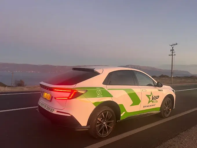 Electric taxi on a mountain road at sunset — long-distance rides from Elbasan